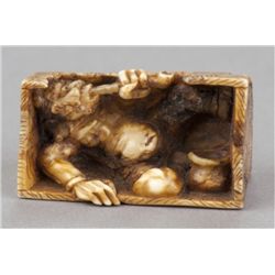 A marine ivory netsuke of an Oni.