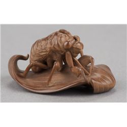 A wood netsuke of a cicada shell.
