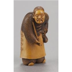 An ivory netsuke of a Chinese man.