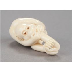 An ivory netsuke of a monkey.