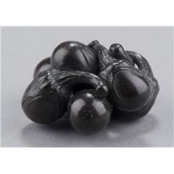 A kaki wood netsuke of an eggplant cluster.
