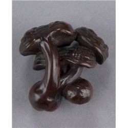 A wood netsuke of reishi mushrooms.