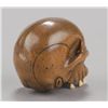 Image 4 : A wood netsuke of a skull with ivory teeth.