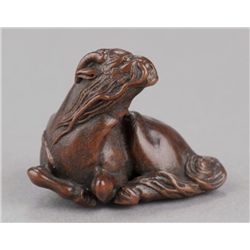 A wood netsuke of a kirin.