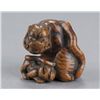 Image 1 : A wood netsuke of a tigress and cub.