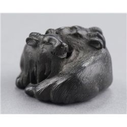 A Kaki wood netsuke of two goats.