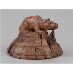 A wood netsuke of a fox.