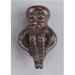 A cherry wood netsuke of an octopus.