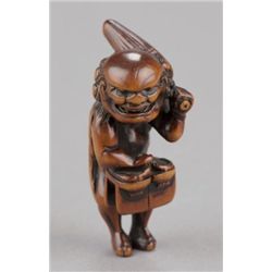 A wood netsuke of a south sea islander.