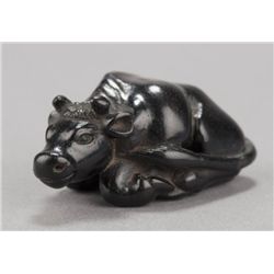 A kaki wood netsuke of an ox.
