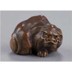 A wood netsuke of a pekinese.