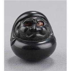 An ebony netsuke of Daruma