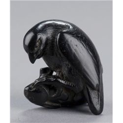 An ebony netsuke of an eagle catching a rabbit.