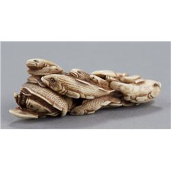 An ivory netsuke of a fish group.