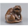 Image 5 : A wood netsuke of a tiger.