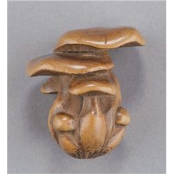 A wood netsuke of mushrooms.