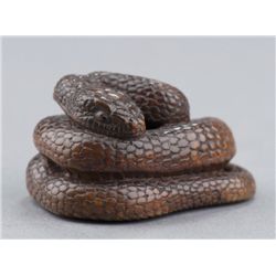 A wood netsuke of a snake.