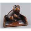 Image 1 : A wood netsuke of a puppy.