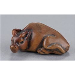 A wood netsuke of an ox.
