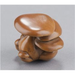 A boxwood netsuke of mushrooms.