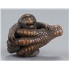 Image 1 : A wood netsuke of a monkey held in Eagle's Claw.