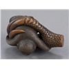 Image 7 : A wood netsuke of a monkey held in Eagle's Claw.