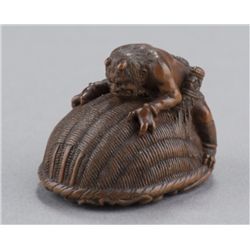 A wood netsuke of Shoki and Oni.