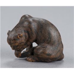 A wood netsuke of a tiger.
