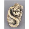 Image 1 : An ivory netsuke of a tiger.