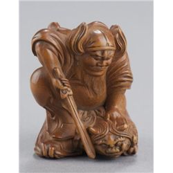 A wood netsuke of Shoki and Oni.