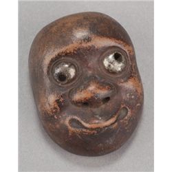 A pottery netsuke of a Beshimi mask.