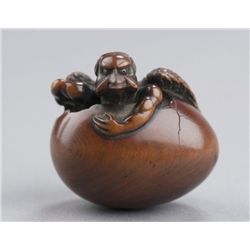 A wood netsuke of Tengu no Tamago.