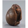Image 1 : A wood netsuke of the hear no evil monkey.