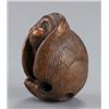 Image 2 : A wood netsuke of the hear no evil monkey.