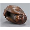 Image 6 : A wood netsuke of the hear no evil monkey.
