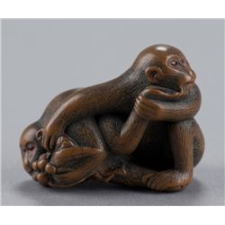A wood netsuke of two monkeys.