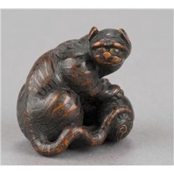 A wood netsuke of a tiger on bamboo.