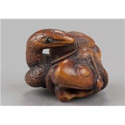 A wood netsuke of San Sukumi.