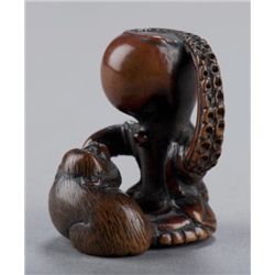 A wood netsuke of an octopus and monkey.