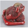 Image 5 : A tsuishu lacquer netsuke of a Shishi.