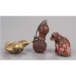 A group of three lacquer netsuke.