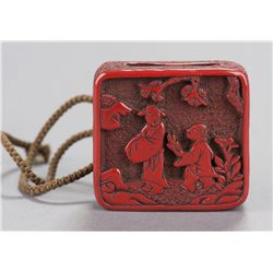 A tsuishu manju of Chinese figures in garden.