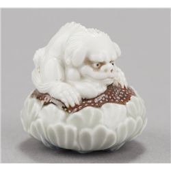 A Hirado-ware netsuke of a Shishi.
