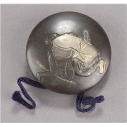 A shibuichi kagamibuta, an archer.