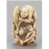Image 1 : A marine ivory netsuke of a fisherman and fish.