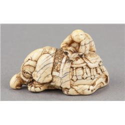 A carved ivory netsuke of an elephant.