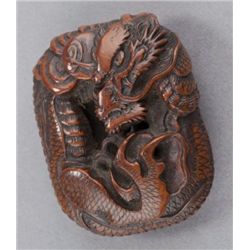A wood manju of a coiled dragon.