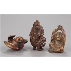 A group of three wood netsuke.