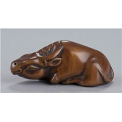 A wood netsuke of an ox.