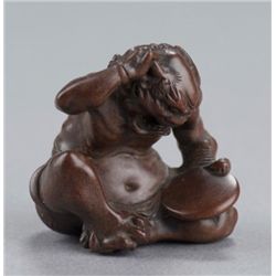A wood netsuke of an oni.
